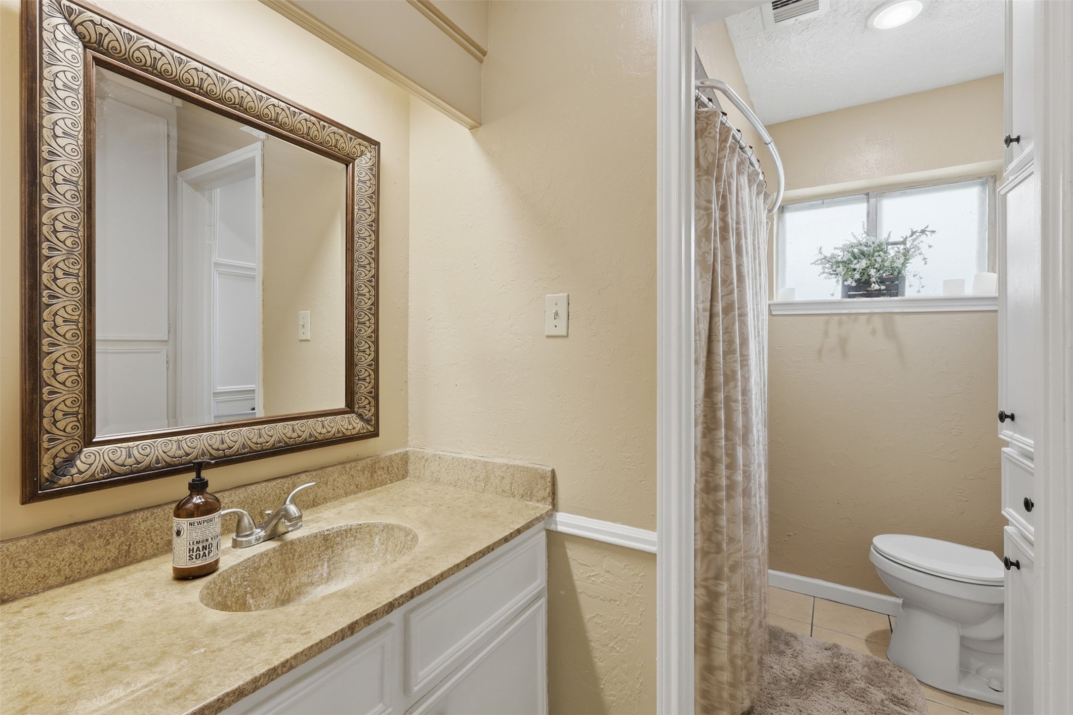 7010 River Mill Drive Spring, TX 77379 - Photo 16 of 29 a bathroom with a granite countertop sink toilet and mirror