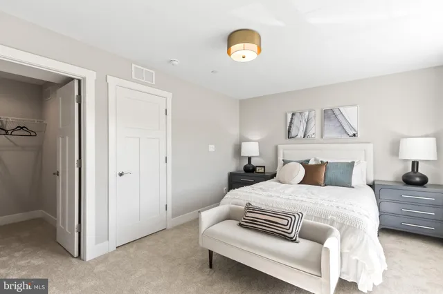 a bedroom with a bed and a mirror