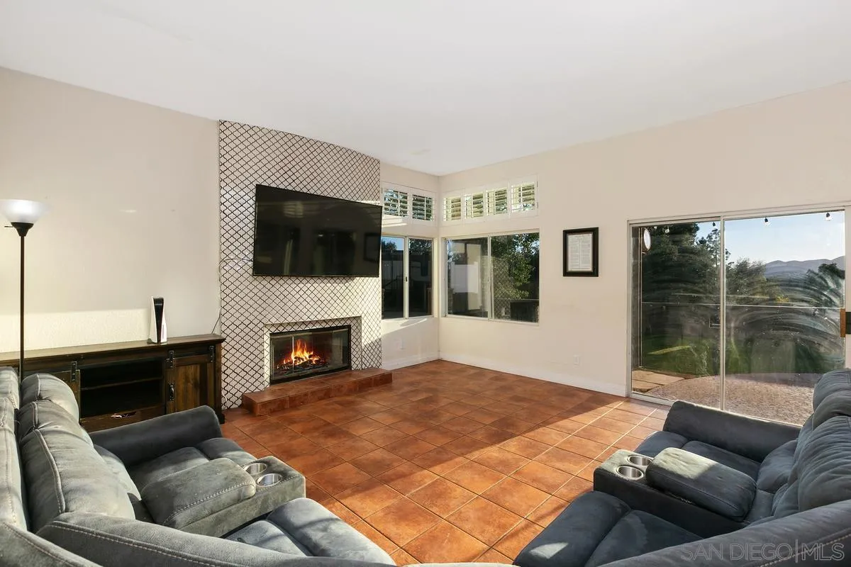 14550 Hidden Wood Road Jamul, CA 91935 - Photo 13 of 51 a living room with furniture a fireplace and a flat screen tv