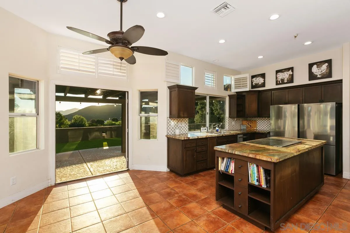 14550 Hidden Wood Road Jamul, CA 91935 - Photo 16 of 51 a kitchen with stainless steel appliances granite countertop a stove and a refrigerator