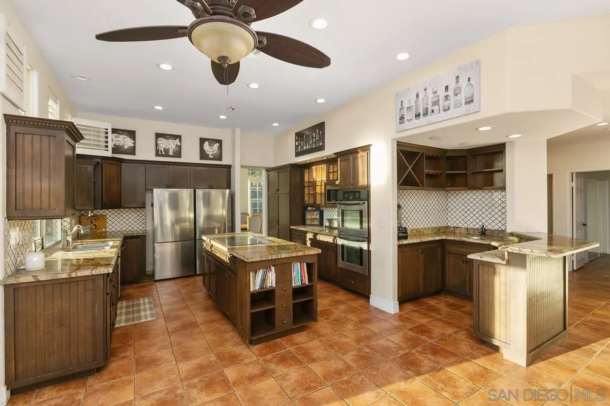 14550 Hidden Wood Road Jamul, CA 91935 - Photo 2 of 51 a kitchen with stainless steel appliances kitchen island granite countertop a refrigerator and a stove