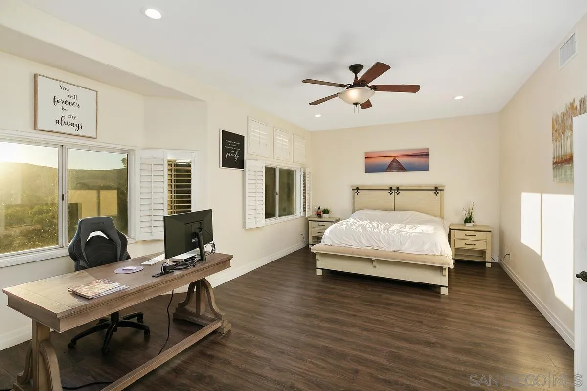 14550 Hidden Wood Road Jamul, CA 91935 - Photo 21 of 51 a bedroom with a bed window and a table