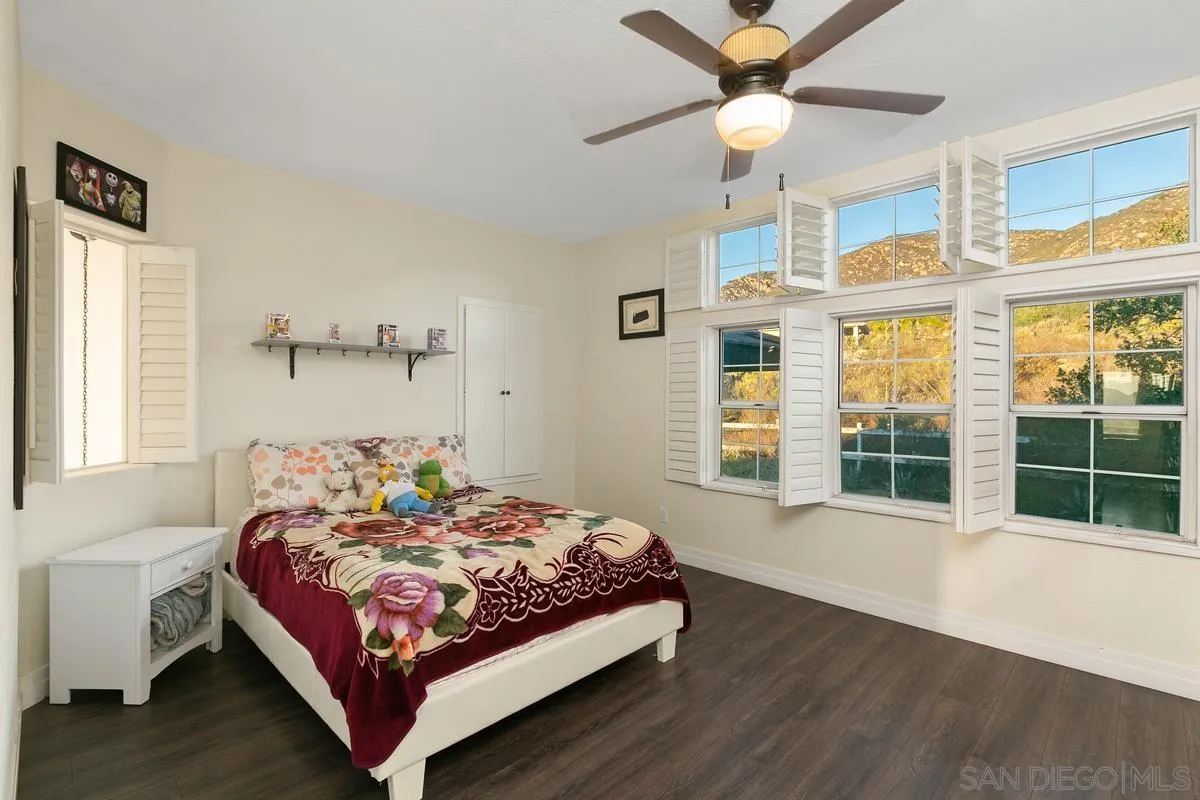 14550 Hidden Wood Road Jamul, CA 91935 - Photo 27 of 51 a bedroom with a bed and window