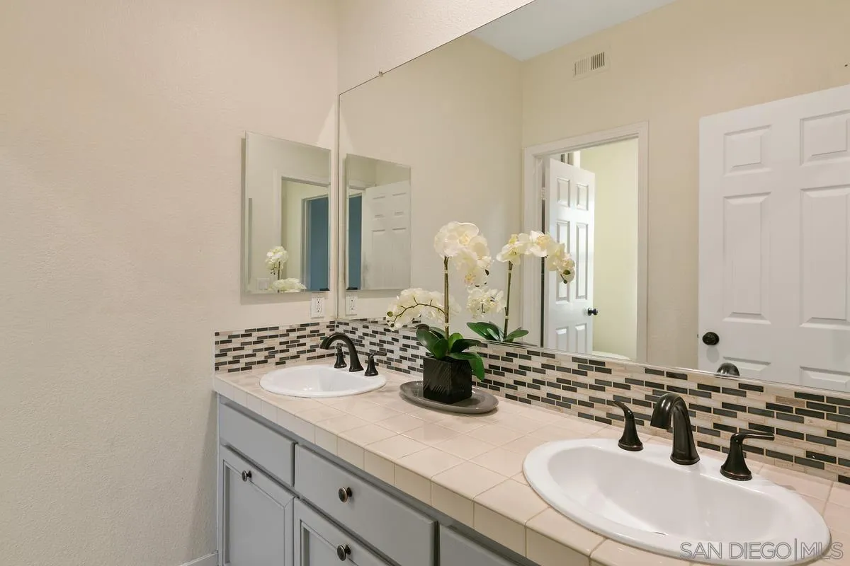 14550 Hidden Wood Road Jamul, CA 91935 - Photo 31 of 51 a bathroom with a sink and a mirror