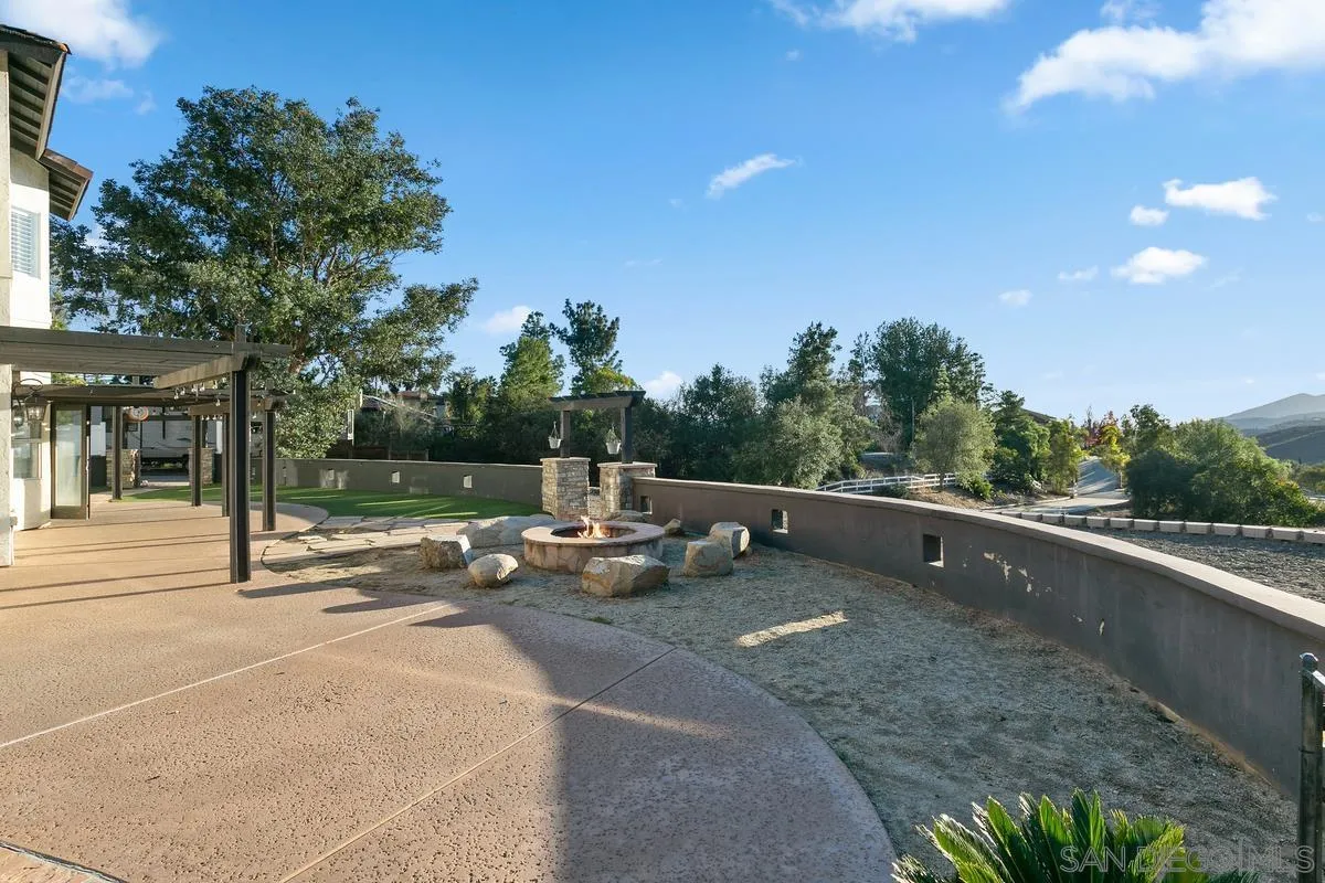14550 Hidden Wood Road Jamul, CA 91935 - Photo 32 of 51 a view of swimming pool with lawn chairs and wooden fence