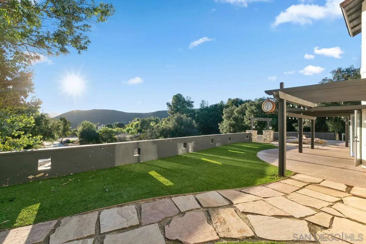 14550 Hidden Wood Road Jamul, CA 91935 - Photo 34 of 51 a view of a patio with a table and chairs under an umbrella