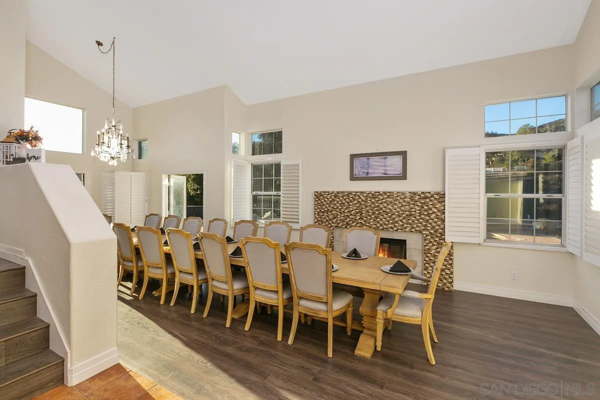 14550 Hidden Wood Road Jamul, CA 91935 - Photo 7 of 51 a dining room with furniture a chandelier and wooden floor