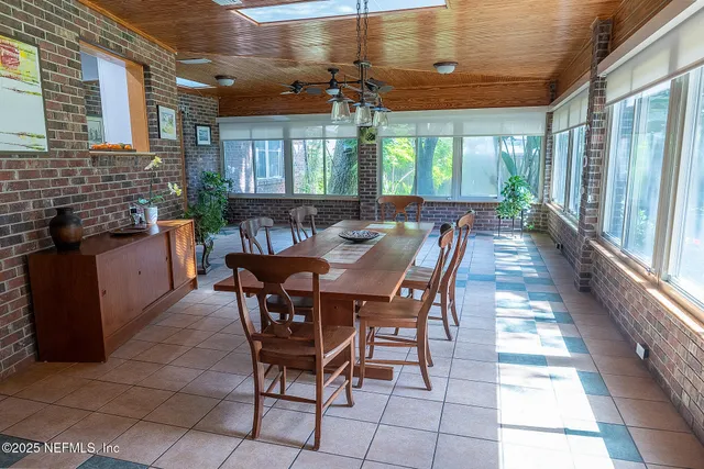 a view of a dining room with furniture and window