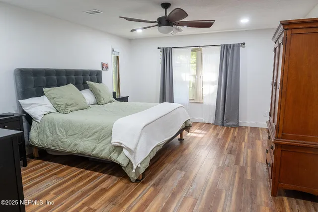 a bedroom with a bed and a window