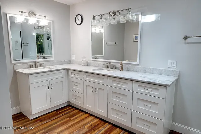 a spacious bathroom with double sink and a mirror