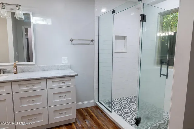 a bathroom with a shower and a sink