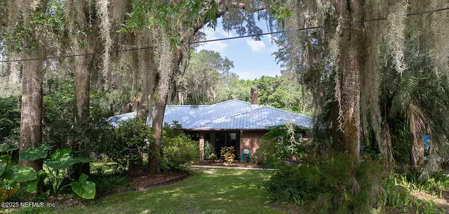 a view of a table and chairs under an umbrella