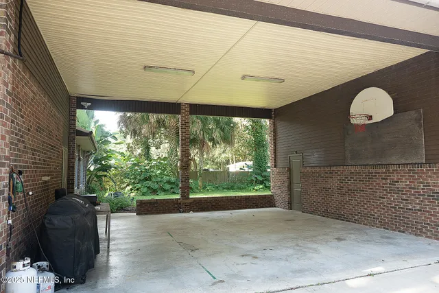 a view of a porch with furniture and floor to ceiling window