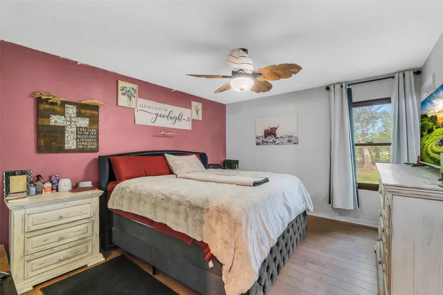 a bedroom with a bed and a chandelier