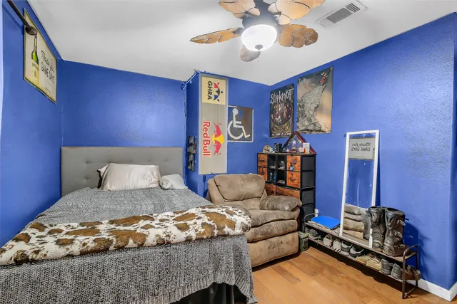 a bedroom with a bed and wooden floor