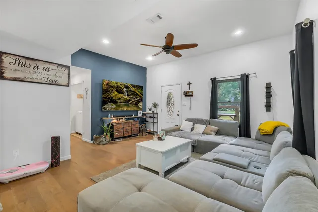 a living room with furniture and a flat screen tv
