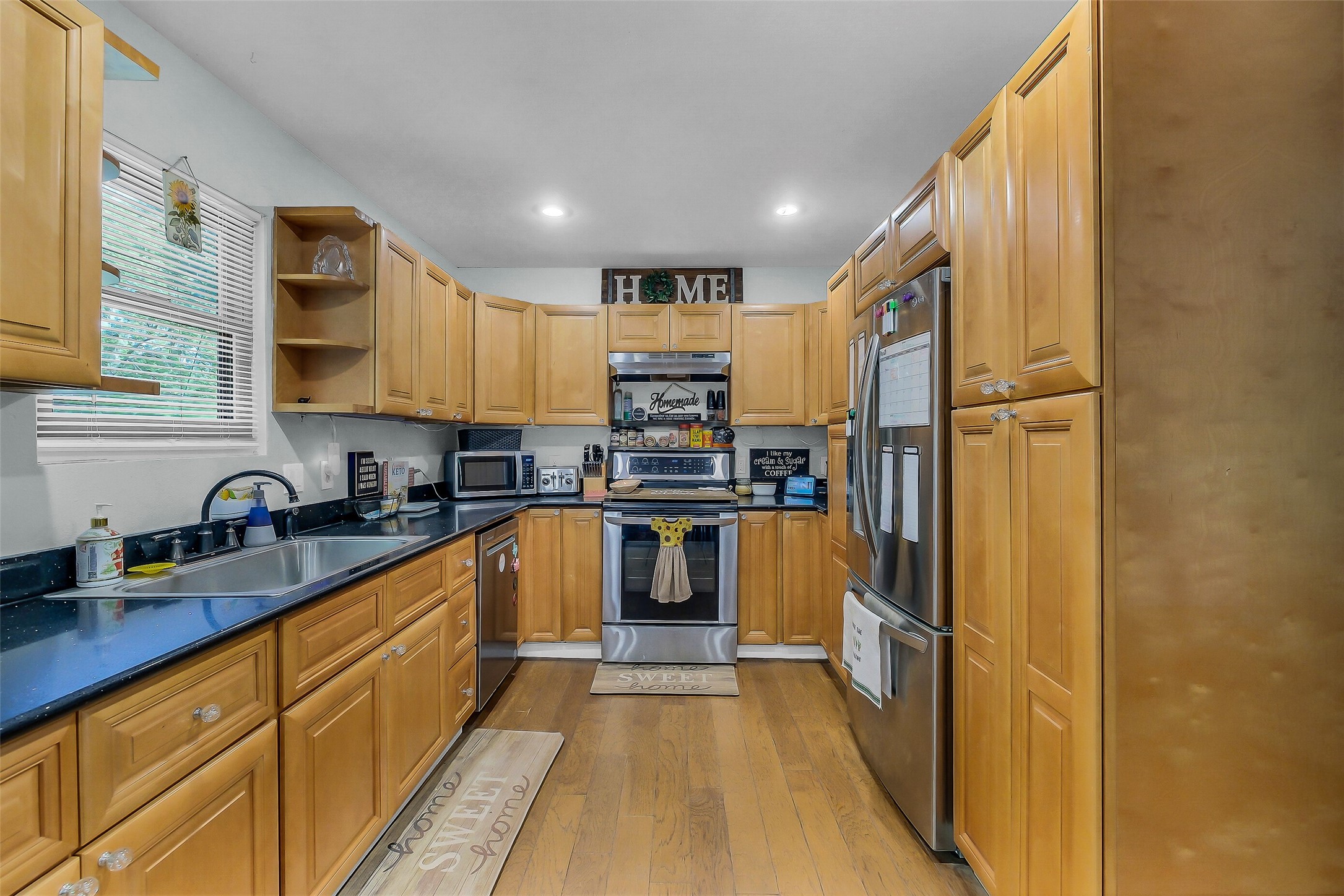 603 Hackamore Road Simonton, TX 77485 - Photo 7 of 21 a kitchen with stainless steel appliances granite countertop a refrigerator and a stove top oven