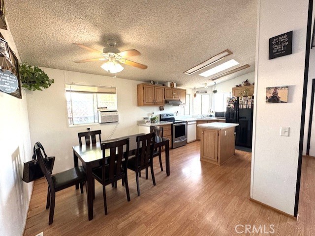 24425 Woolsey Canyon Road, Unit 196 West Hills, CA 91304 - Photo 20 of 29 a view of a dining room with furniture and a chandelier