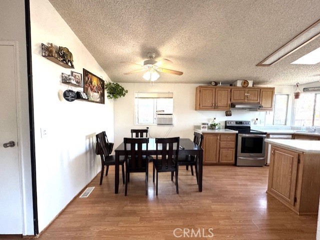 24425 Woolsey Canyon Road, Unit 196 West Hills, CA 91304 - Photo 21 of 29 a kitchen with kitchen island granite countertop a sink table and chairs