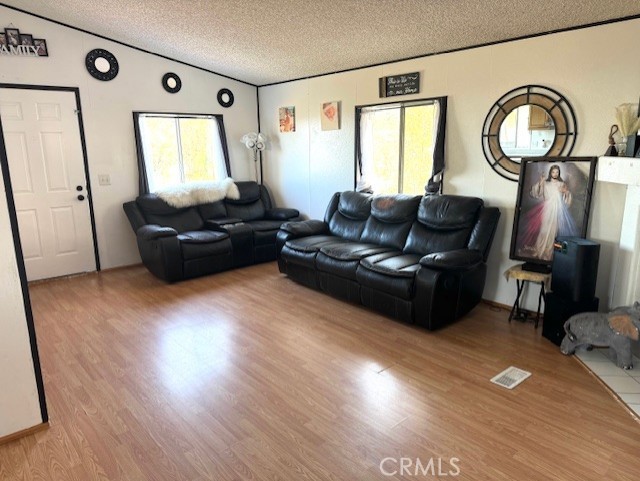 24425 Woolsey Canyon Road, Unit 196 West Hills, CA 91304 - Photo 23 of 29 a living room with furniture windows and wooden floor