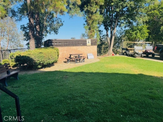 24425 Woolsey Canyon Road, Unit 196 West Hills, CA 91304 - Photo 26 of 29 a view of a park with bench and trees