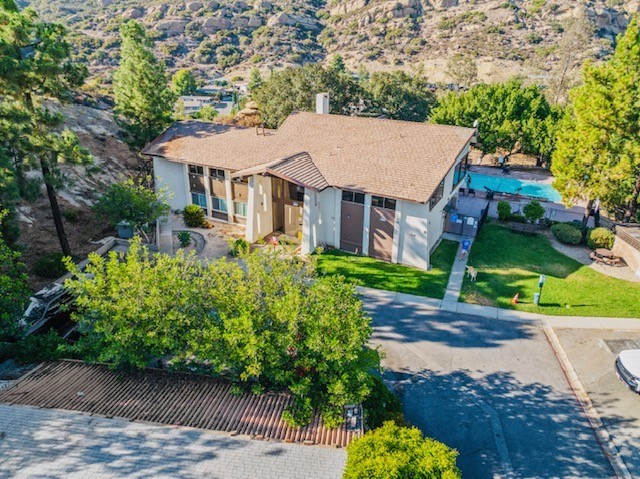 24425 Woolsey Canyon Road, Unit 196 West Hills, CA 91304 - Photo 27 of 29 a aerial view of a house with a yard and potted plants