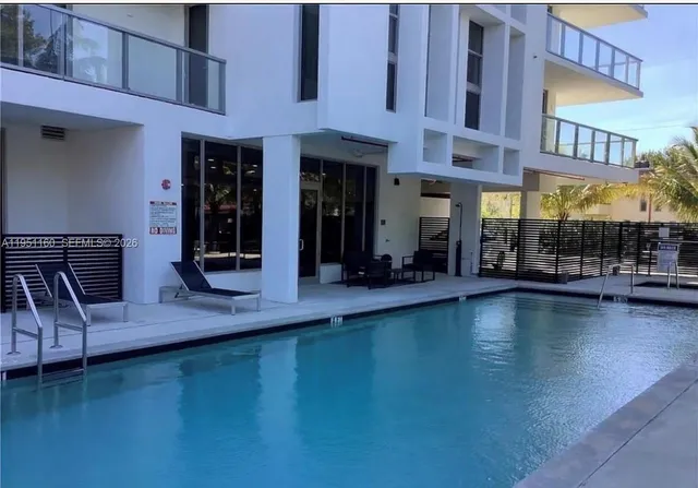a view of a building with pool table and chairs