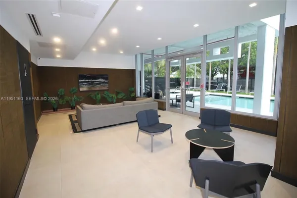 a large room with wooden cabinets and stainless steel appliances