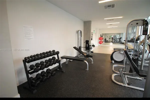 a room with gym equipment and a large window