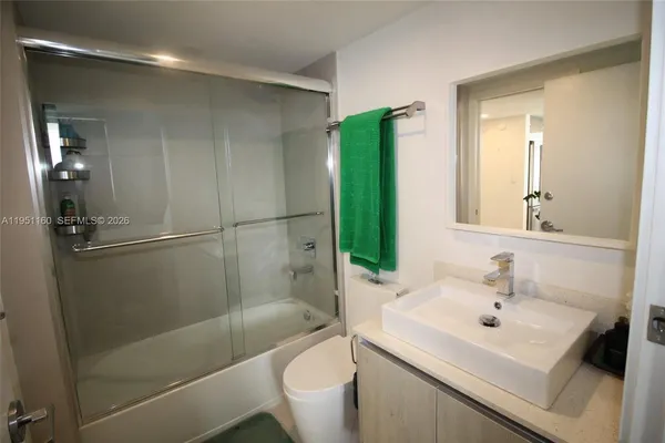 a bed room with a bed window and a desk