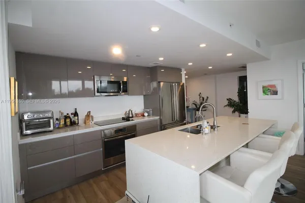 a kitchen with sink cabinets and wooden floor