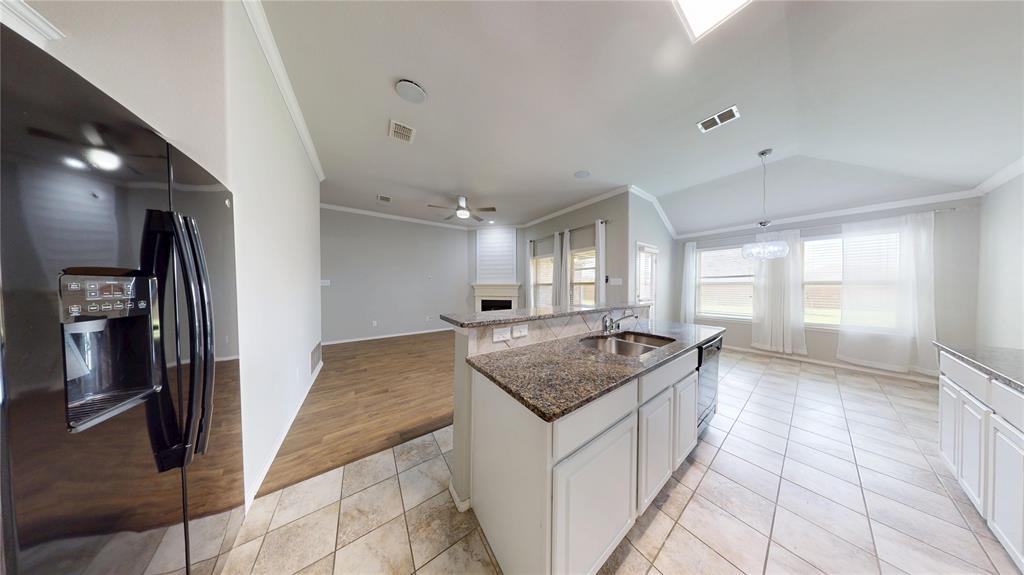 3101 Buckthorn Street Forney, TX 75126 - Photo 3 of 40 Kitchen with island sink, granite countertops, white cabinetry, and tile flooring