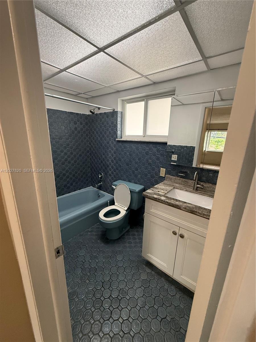 6841 Pembroke Road, Unit 15 Pembroke Pines, FL 33023 - Photo 12 of 16 a bathroom with a sink and mirror