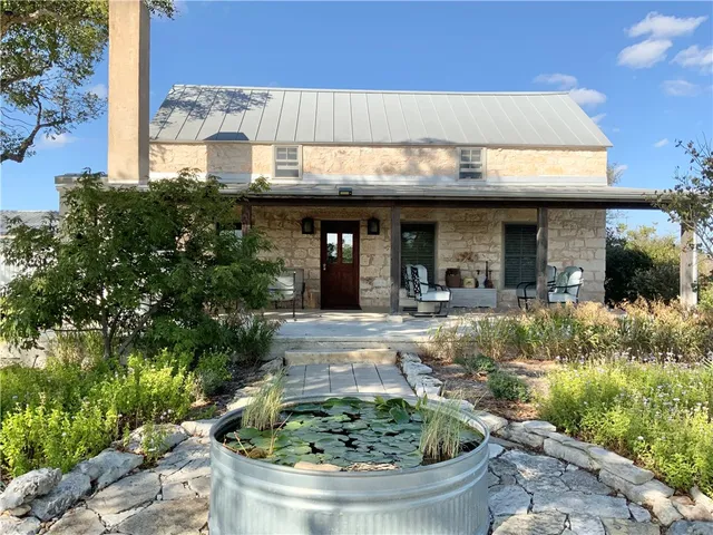 a view of a house with fountain in front of it