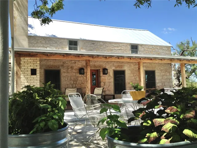 a front view of house with outdoor seating