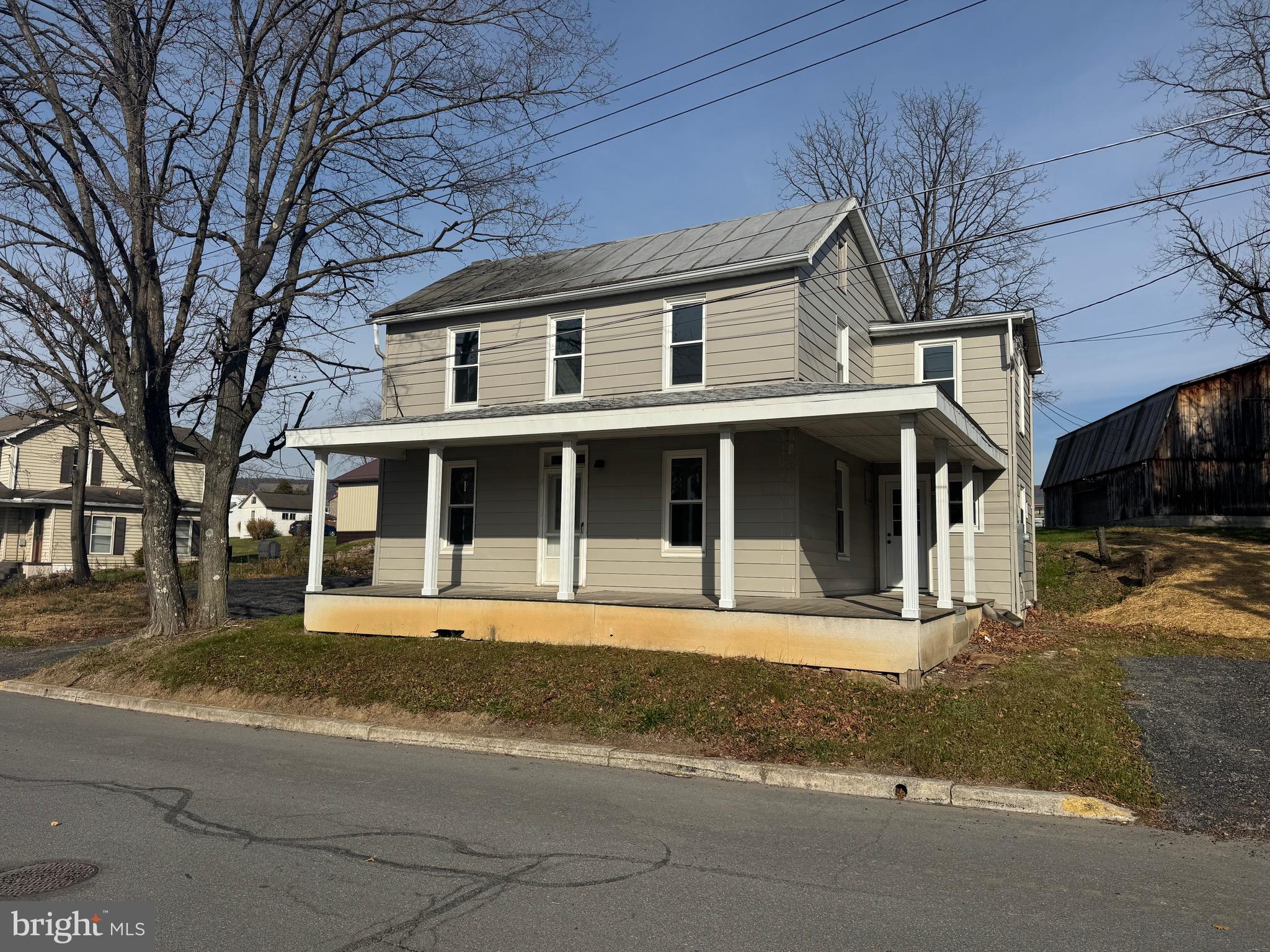 85 Maclay Street Milroy, PA 17063 - Photo 1 of 24 a front view of a house with a yard and garage