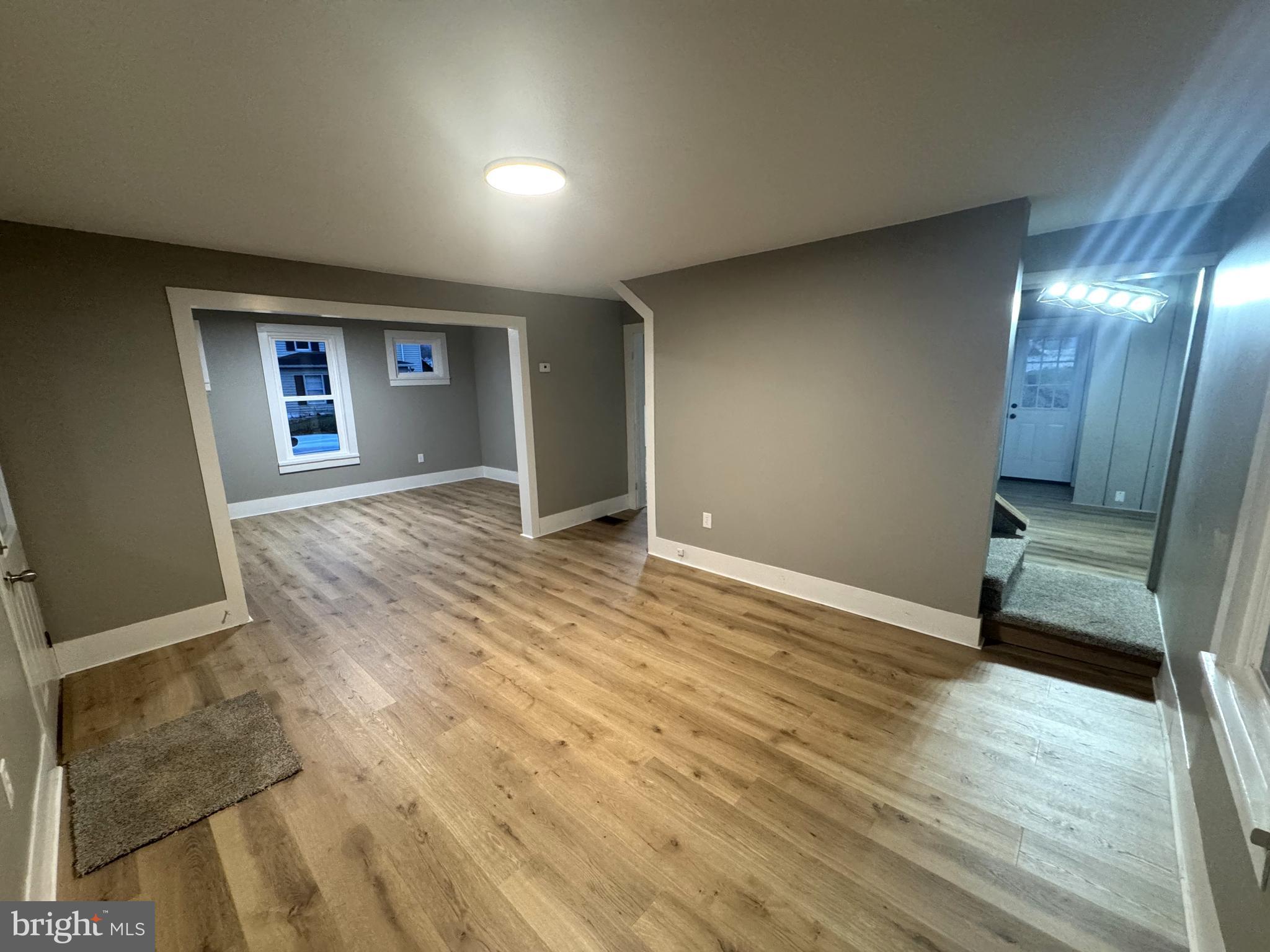 85 Maclay Street Milroy, PA 17063 - Photo 11 of 24 an empty room with wooden floor and windows