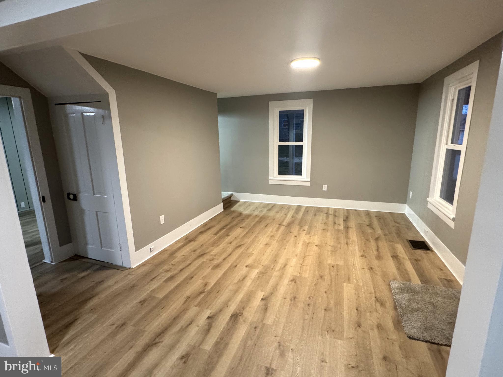 85 Maclay Street Milroy, PA 17063 - Photo 12 of 24 wooden floor in an empty room with a window