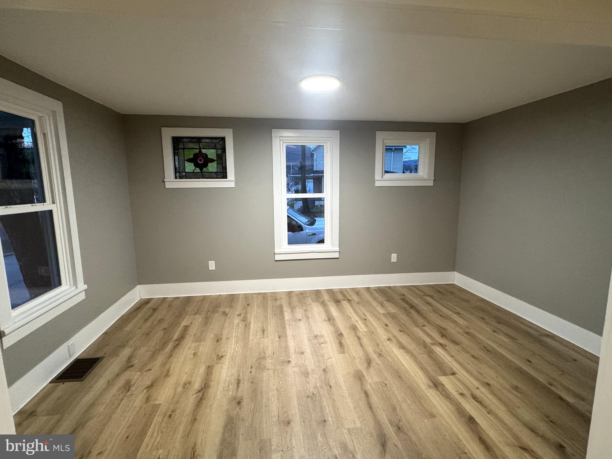 85 Maclay Street Milroy, PA 17063 - Photo 13 of 24 a view of an empty room with wooden floor and a window