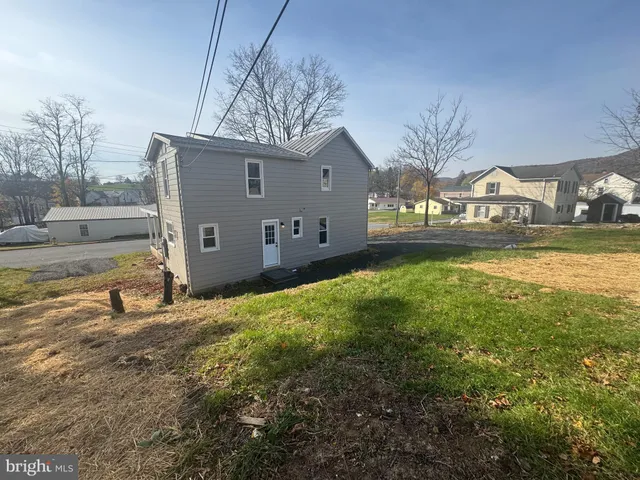 a view of a house with a yard and a garage