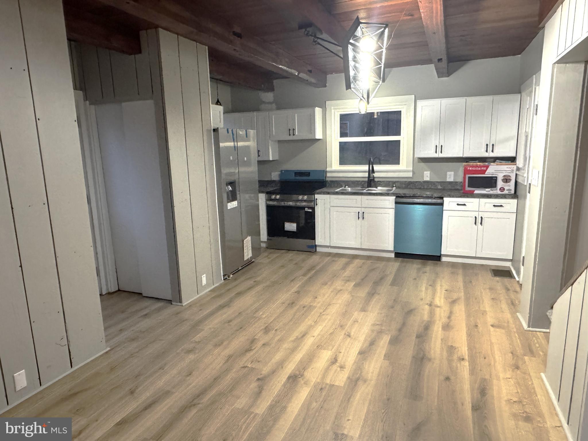 85 Maclay Street Milroy, PA 17063 - Photo 5 of 24 a kitchen with granite countertop white cabinets and stainless steel appliances