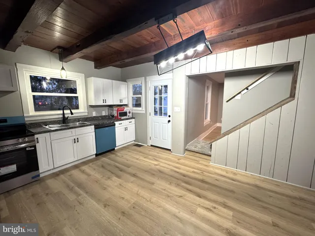 a kitchen with stainless steel appliances granite countertop a stove sink and cabinets