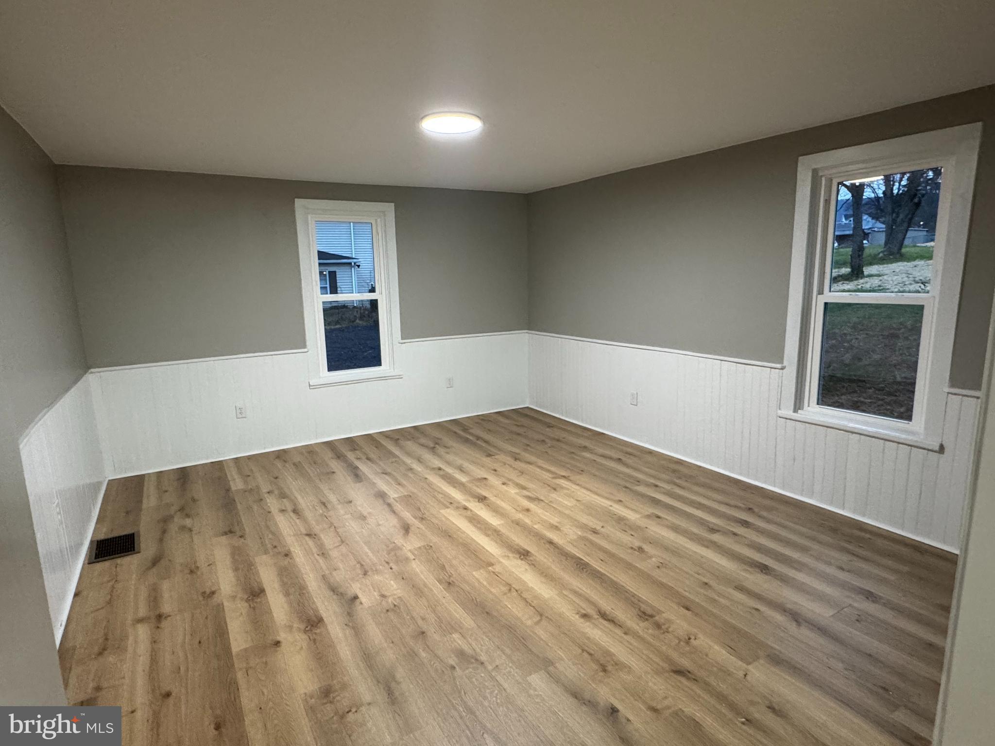 85 Maclay Street Milroy, PA 17063 - Photo 9 of 24 a view of empty room with wooden floor and fan