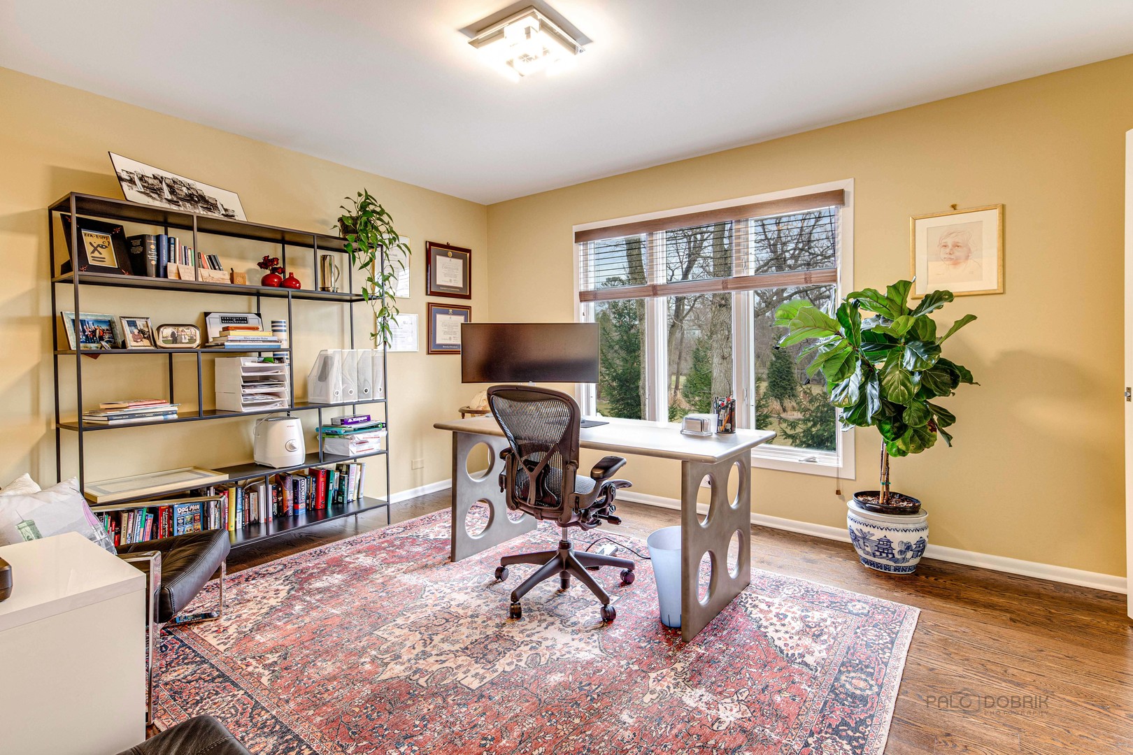 783 Valley Road Glencoe, IL 60022 - Photo 35 of 45 a living room with furniture a bookshelf and a potted plant