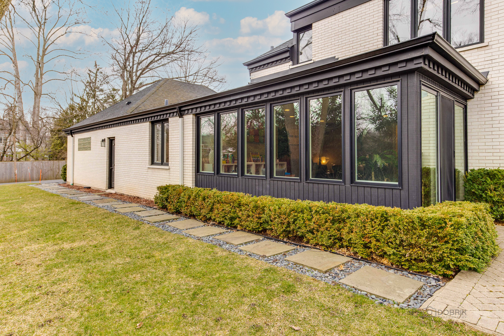 783 Valley Road Glencoe, IL 60022 - Photo 42 of 45 a view of a house with a large window and wooden fence