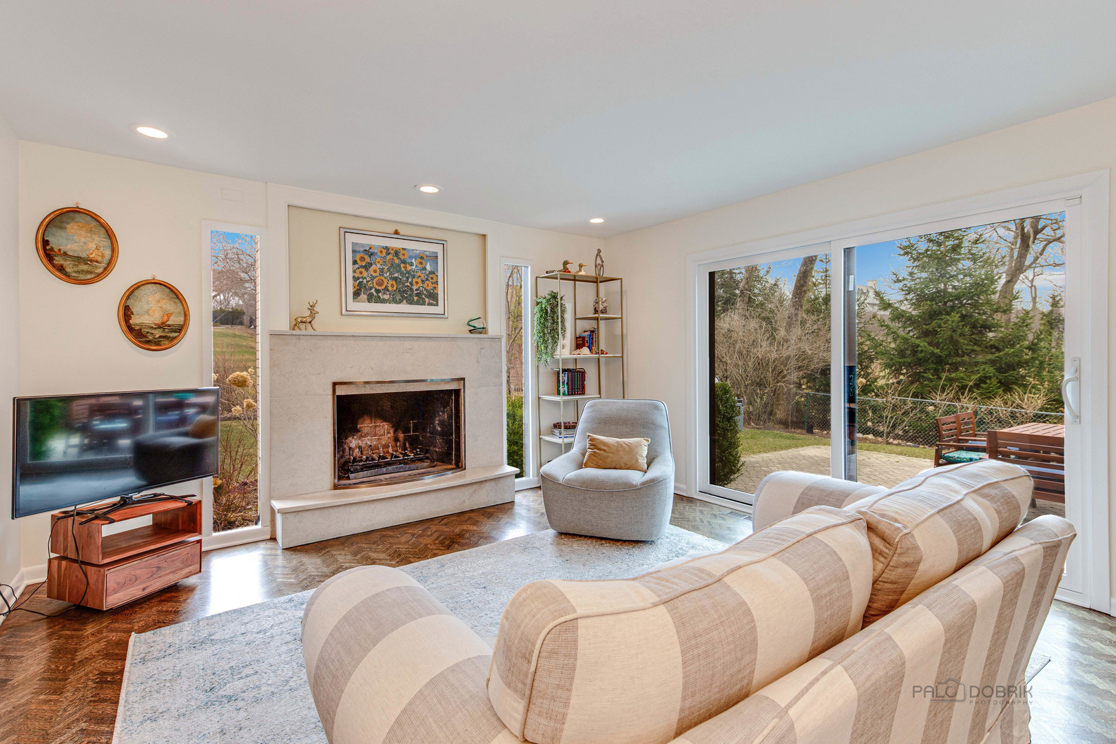 783 Valley Road Glencoe, IL 60022 - Photo 8 of 45 a living room with furniture a fireplace and a large window