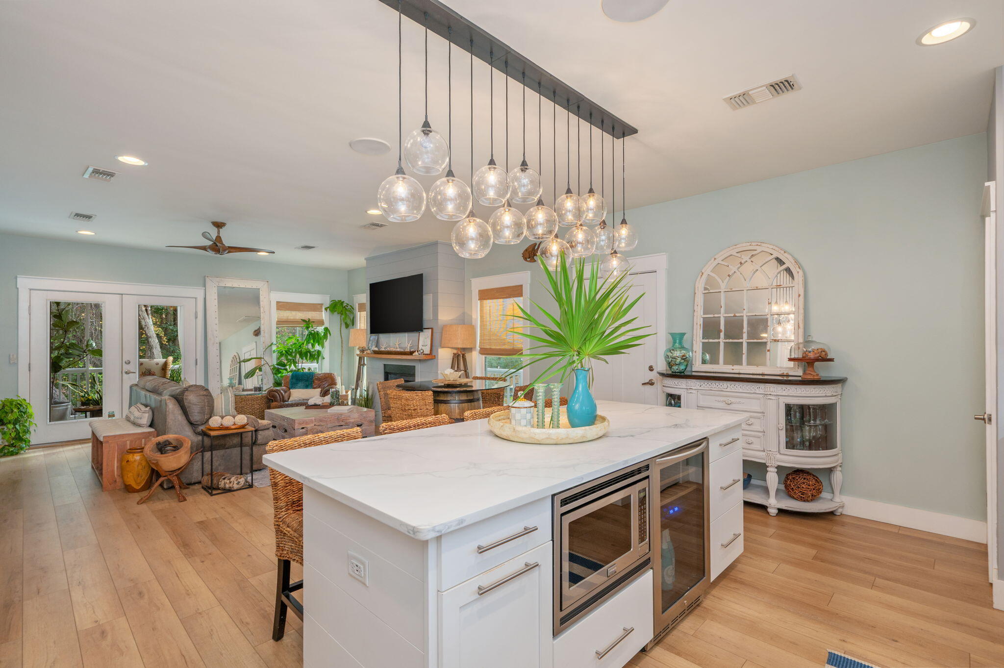 903 Lido Circle East Niceville, FL 32578 - Photo 11 of 64 a view of a kitchen with kitchen island granite countertop a stove a sink and a dining table with chandelier