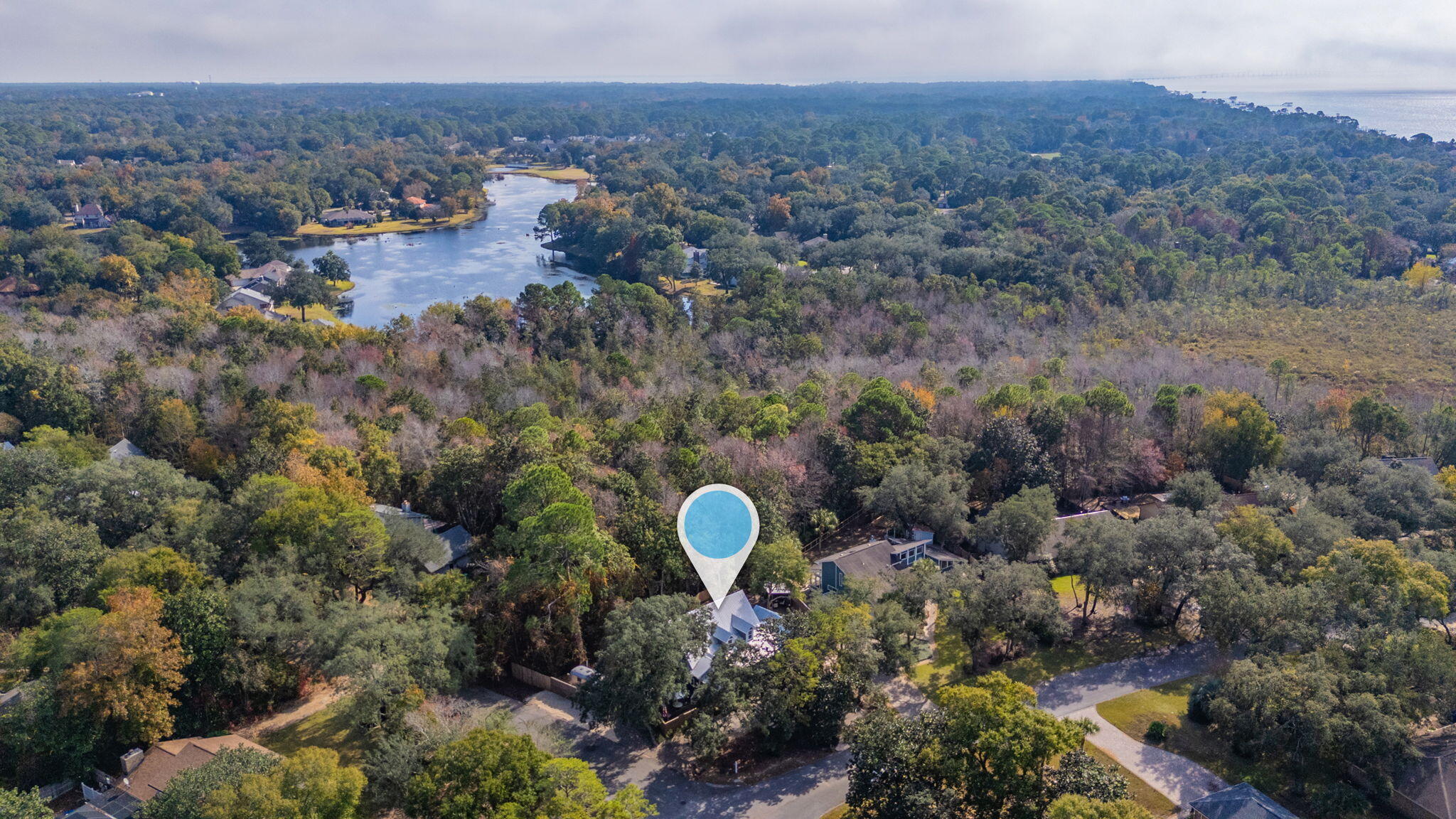 903 Lido Circle East Niceville, FL 32578 - Photo 63 of 64 a aerial view of a house with a yard and a large tree