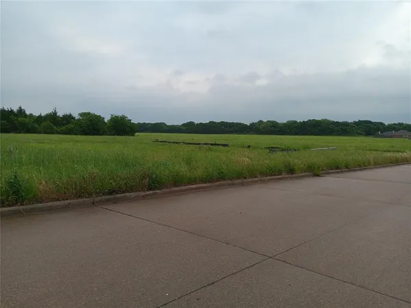 an aerial view of a house with a yard and lake