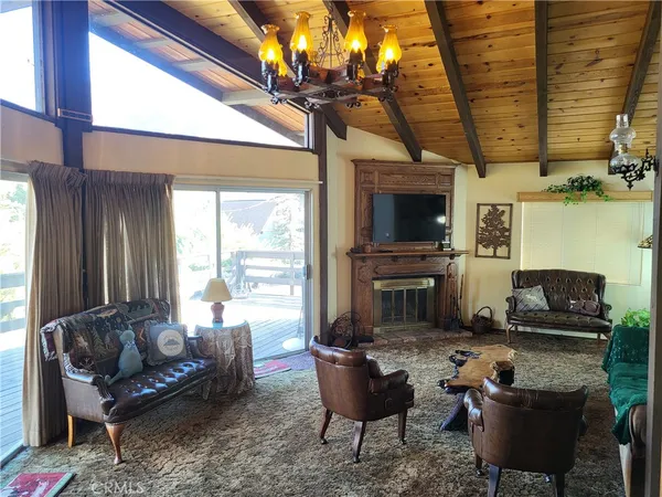 a living room with furniture a flat screen tv and a large window